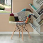 Patchwork fabric lounge chair with wooden legs in a modern interior