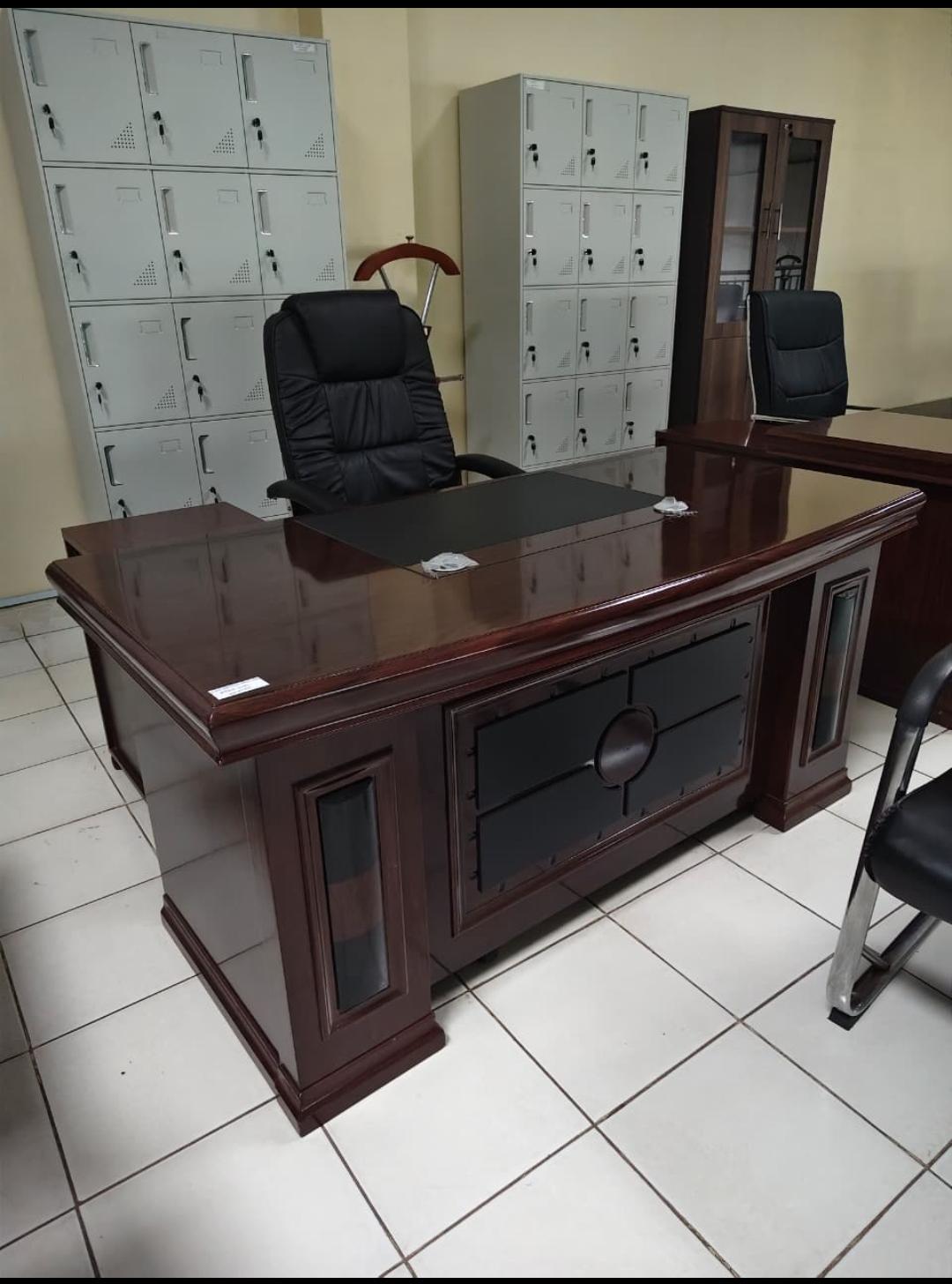 Mahogany executive director desk and high back leather chair in a modern commercial office