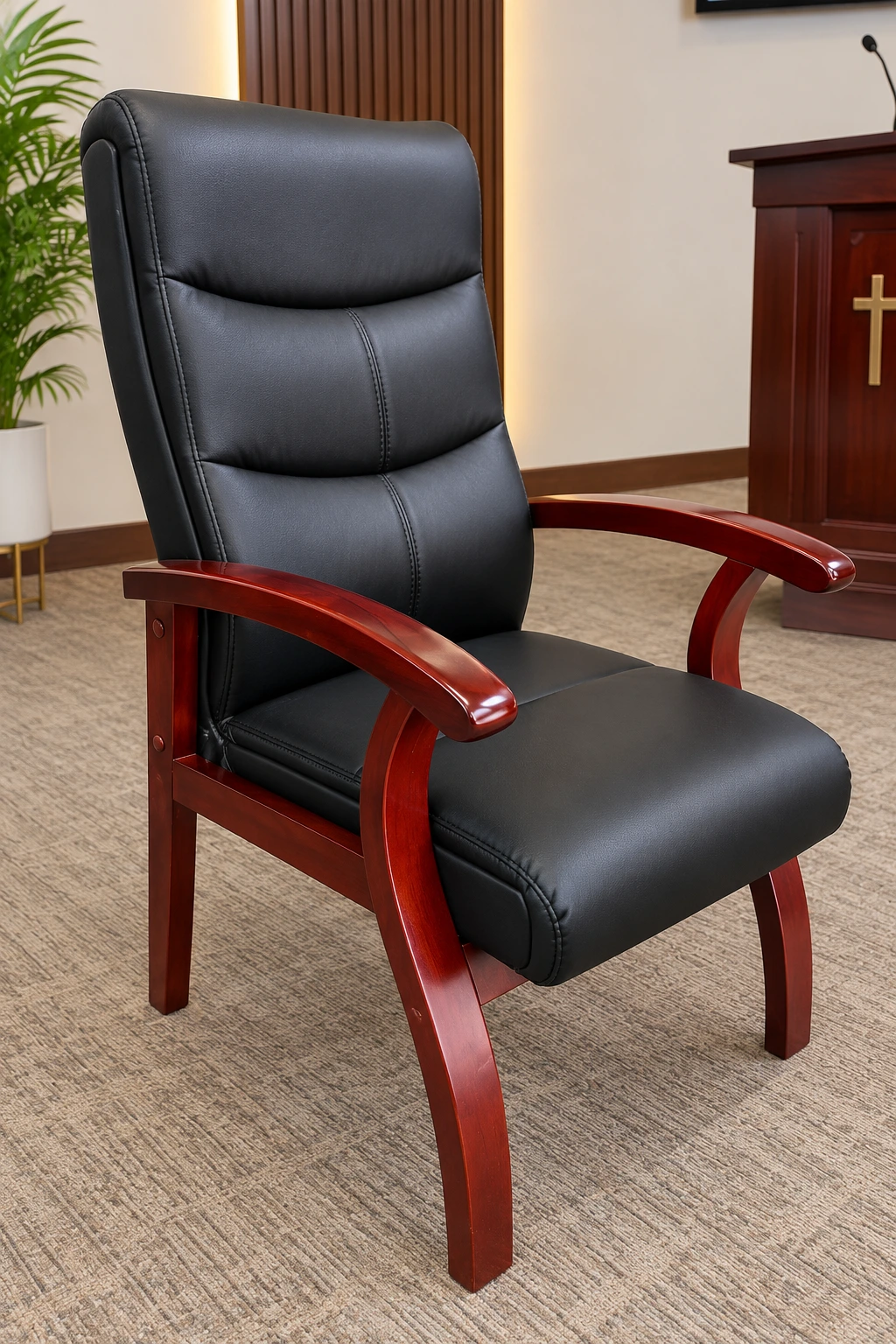 Black upholstered pastor's chair with polished wooden frame and armrests