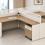 Modern two-seater L-shaped office desk with integrated storage for a shared workspace.