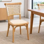 Wooden restaurant dining chair with woven backrest and cushioned seat.