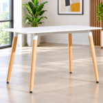 Minimalist restaurant table with white top and natural wooden legs in a commercial dining space